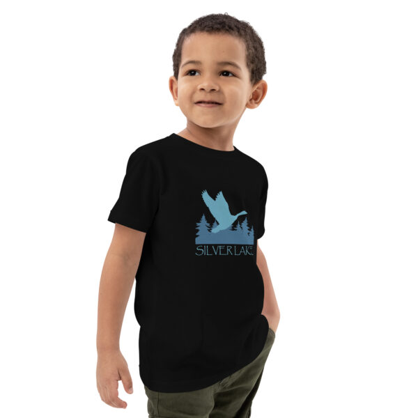 organic cotton kids t shirt black right front with a stylized teal blue logo for 'History of Silver Lake' book: A single goose flying over Silver Lake with trees in the background.