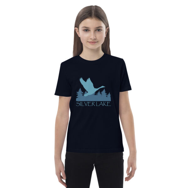 organic cotton kids t shirt french navy front with a stylized teal blue logo for 'History of Silver Lake' book: A single goose flying over Silver Lake with trees in the background.