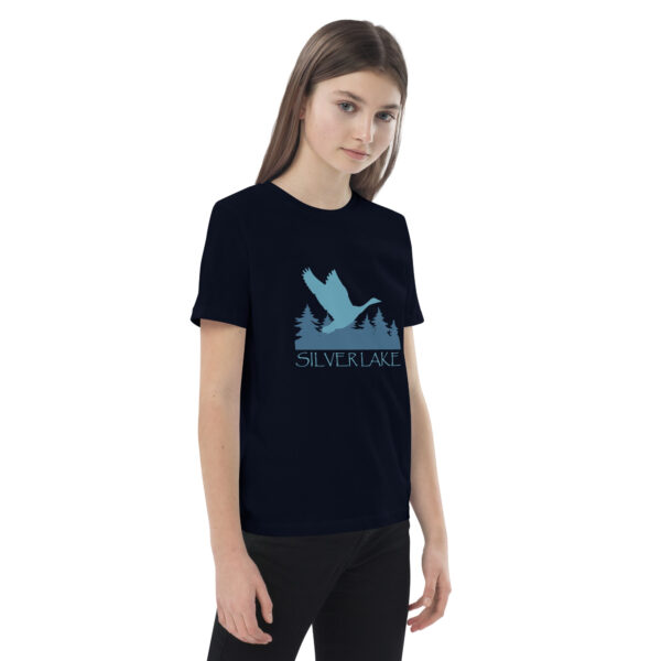 organic cotton kids t shirt french navy right front with a stylized teal blue logo for 'History of Silver Lake' book: A single goose flying over Silver Lake with trees in the background.