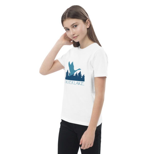 organic cotton kids t shirt white left front with a stylized teal blue logo for 'History of Silver Lake' book: A single goose flying over Silver Lake with trees in the background.