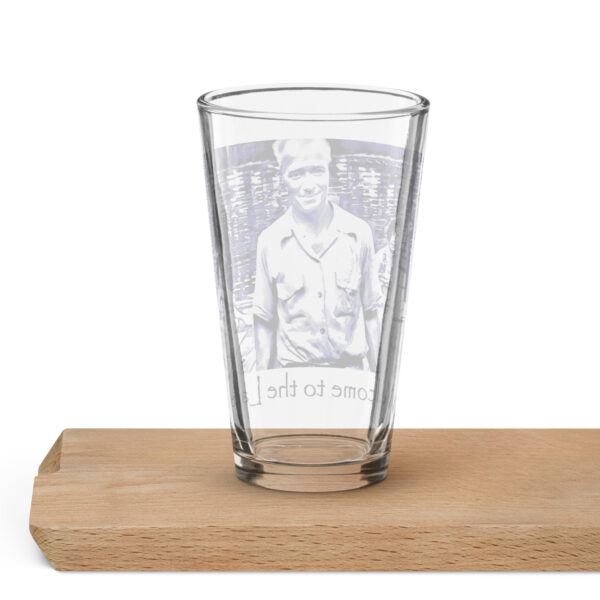 shaker pint glass 16 oz 16 oz back with image of the book cover for 'The History of Silver Lake as Told Through Its Deeds' showing, Pappy, in foreground from the "Great Book! No Cicadas!" billboard, two young women in a canoe behind him, and a young girl peeking from behind a tree saying ‘Welcome to the Lake’ on the historyofsilverlake.com website.