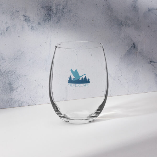 stemless wine glass 15 oz front with a stylized teal blue logo for 'History of Silver Lake' book: A single goose flying over Silver Lake with trees in the background.