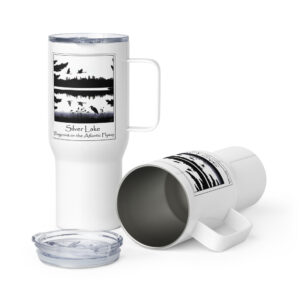 travel mug with a handle white 25 oz front with an image of Silver Lake featuring a blue heron in the foreground and Canada Geese in flight overhead, highlighting Silver Lake as a waypoint on the American Atlantic Flyway from the book "The History of Silver Lake as Told Through Its Deeds".