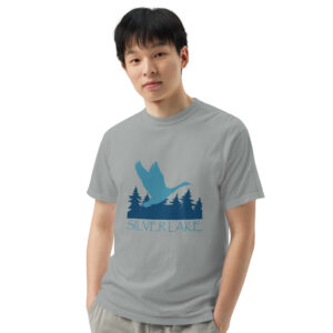 unisex garment dyed heavyweight t shirt granite front with a stylized teal blue logo for 'History of Silver Lake' book: A single goose flying over Silver Lake with trees in the background.