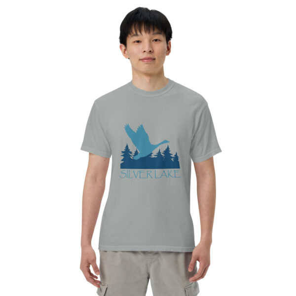 unisex garment dyed heavyweight t shirt granite front with a stylized teal blue logo for 'History of Silver Lake' book: A single goose flying over Silver Lake with trees in the background.